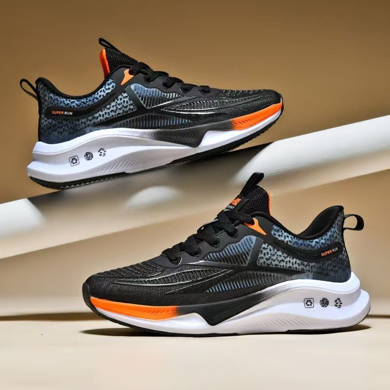 “Men’s ultralight black running sneakers with orange accents, breathable mesh upper, and cushioned soft-bottom sole – Trend Step”