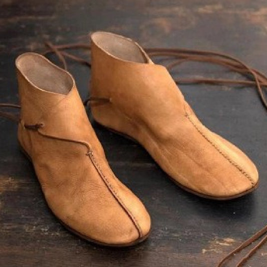 “Vintage men’s brown flat round-toe leather lace-up boots on wooden surface – Trend Step”